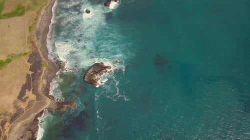 Aerial Drone Shot of Turquoise Ocean Water and White Waves at the Seashore