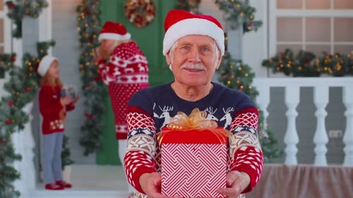 Elderly Man Holds Christmas Gift