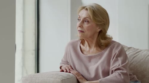 Mature Woman Sitting and Thinking