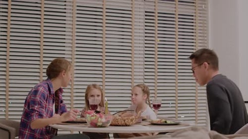 Family Eats Dinner Together at Home Around Table