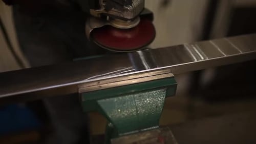 Worker Cutting Metal with Grinder