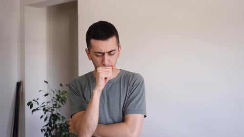 Sick Young Man Coughing Inside His House, COVID-19 Symptoms. - medium shot