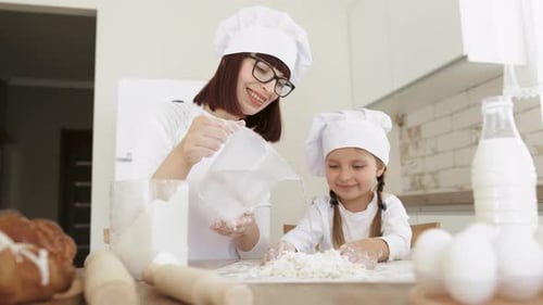 Mother and Child Baking Together in Kitchen