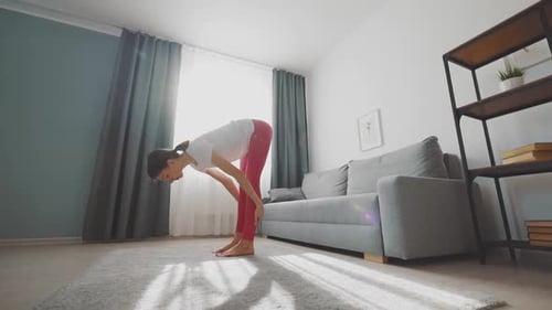 Woman Doing Hamstring Stretch Exercise Indoors