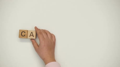 Wooden Blocks Spell Out 'Care' With Stacking Hands