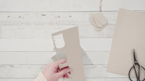 Crafting Gift Tags With Puncher Tool on White Table