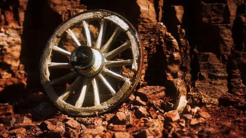 Old Wooden Cart Wheel on Stone Rocks