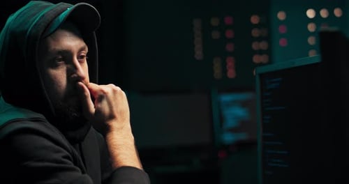 A Middleaged Bearded Hacker in a Hoodie Breaks Into the Company's Servers From His Underground