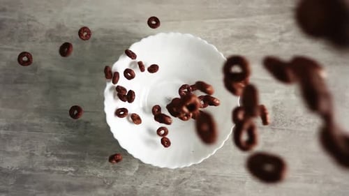 Chocolate Cereal Rings Poured Into White Bowl