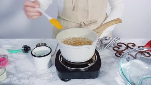 Step by step. Caramelizing sugar in a small cooking pot over the small electric stove