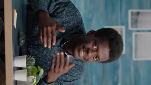 Smiling Man Talks To Camera in Home Office
