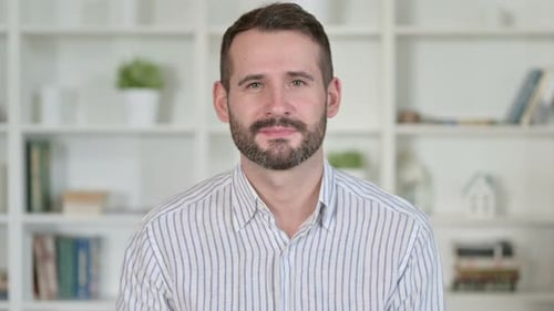 Smiling Man Waving Hello Indoors