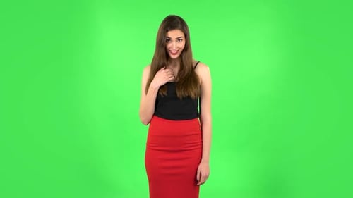 Indignant Woman Throwing Up Hands Expressing She Is Innocent, Twists His Finger at His Temple. Green