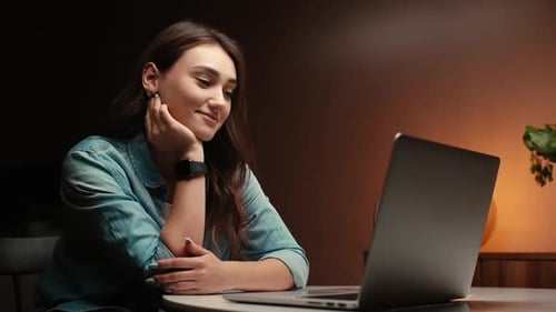 Closeup View of Pretty Young Woman Chatting Online on Laptop Camera at Dark Living Room