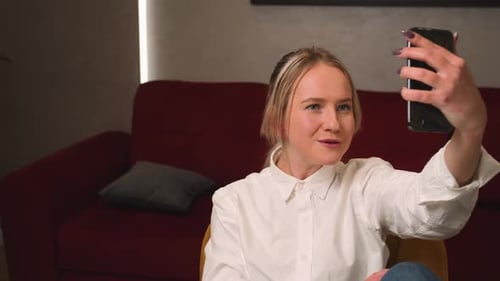 Woman Talking on Phone Video Call Indoors