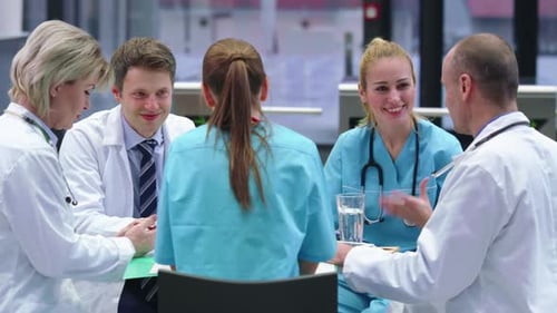 Health Professionals Collaborate Around a Table in Hospital