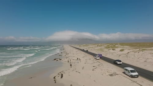 Cars Driving on Road Along Coast