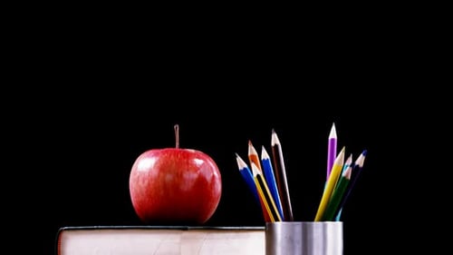 Books, Apple, and Pencils on a Desk