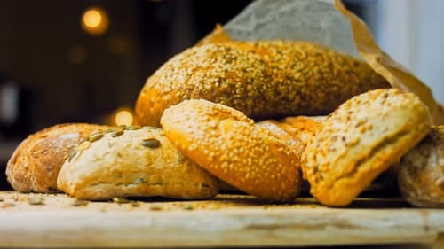Selection of Freshly Baked Bread on Wooden Surface