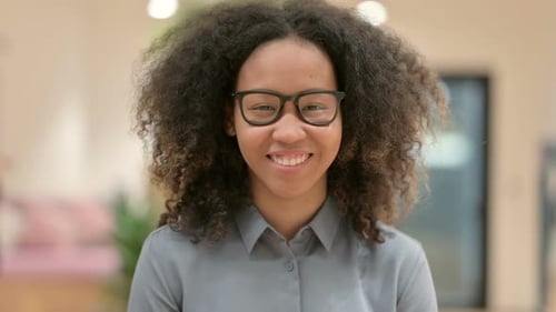 Smiling Woman with Curly Hair and Glasses Portrait