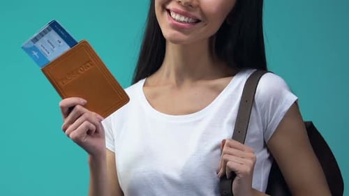 Young Woman Holding Passport and Boarding Pass