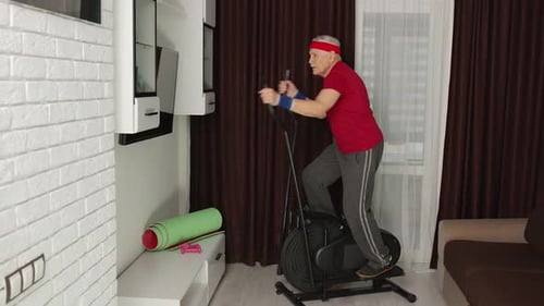 Active Senior Man Exercising on Elliptical at Home
