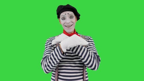 Mimo que sostiene tocando una pared imaginaria y haciendo un pájaro imaginario en una pantalla verde, Chroma Key.