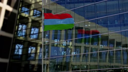 Three-Color Flag Waving in Front of Modern Corporate Building