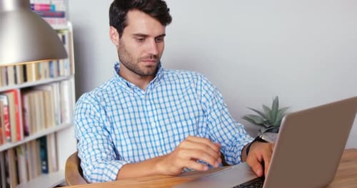 Concentrated Man Using Laptop