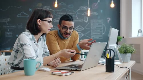 Slow Motion of Mixed Race Coworkers Talking in Office Looking at Laptop Screen