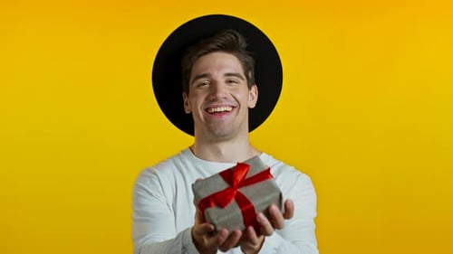 Cheerful Young Adult Holding a Birthday Gift