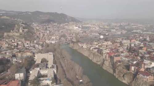 Aerial view of Metekhi church in old Tbilisi located on cliff near river Kura. Georgia 2021 winter