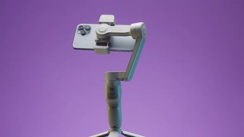 Smartphone on White Handheld Gimbal Rotating on Purple