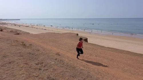 A Middleaged Woman Overweight Trains Cardio Jogging on the Beach for Weight Loss