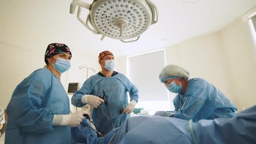 Surgeons Team Preforming Operation in Hospital Operating Theater Male Surgeon