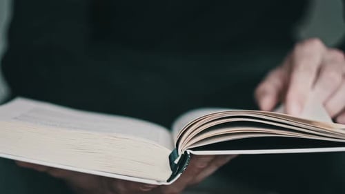 Reading a Book and Turning the Pages Close Up Slow Motion