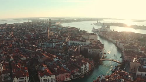 Beautiful drone shot over Grand canal towards Basilica di Santa Maria Venice Italy at sunrise