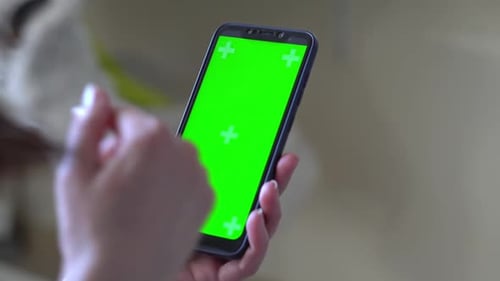 Young Woman at Modern Room Using Smartphone Mobile Phone with Green White