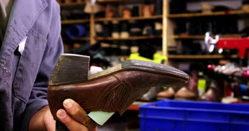 Craftsman Handcrafting Leather Shoe in Workshop