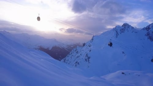 Aerial drone view of a ski gondola lift and mountains at a ski resort