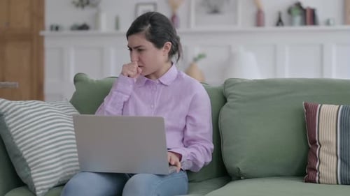 Woman Coughing While Using Laptop on Couch