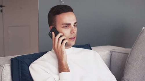 Man talking on mobile phone indoors