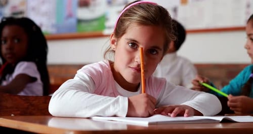 Little girl colouring in the classroom
