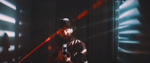 Man with Handgun in Dark Urban Interior at Night