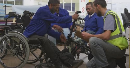 Wheelchair Factory Workers Repairing Building Assembling Wheelchair