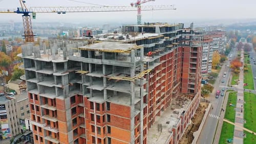 Multi-storey building under construction. Building cranes are working. Aerial view.