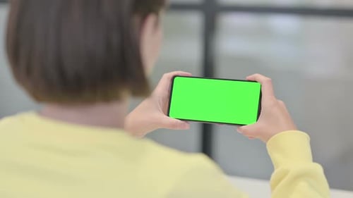 Woman Looking at Smartphone with Green Screen