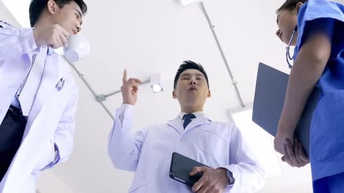 Team of doctors talking in hospital. Group of medical staff discussing in clinic.