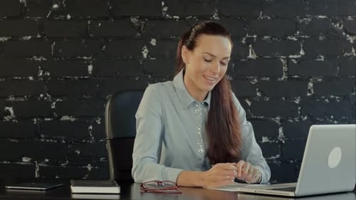 Young Businesswoman Videochatting With Colleagues On Computer In Office