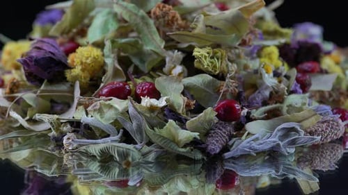 Dried Flowers and Berries on Reflective Surface